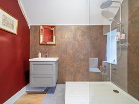 A bathroom with a sink and shower at Furzen Farmhouse