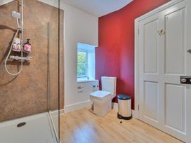 A bathroom with a shower and toilet at Furzen Farmhouse