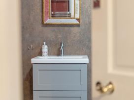 A sink and mirror in a bathroom at Furzen Farmhouse