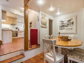 A dining room with a table and chairs at Quay Cottage