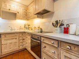 A kitchen with cabinets and countertop at Quay Cottage