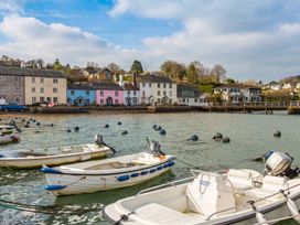 A view of boats in the water beside houses at Quay Cottage in 