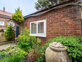 A garden with a brick wall and plants at a residential property in the UK