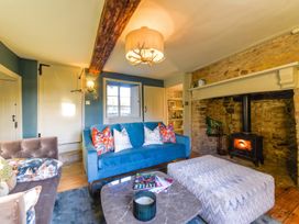 A living room with a blue sofa and coffee table at The Old Barn in Manchester