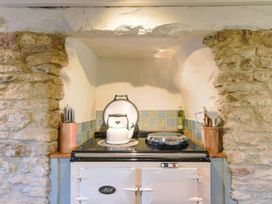 A kitchen with an oven, kettle, and utensils at The Old Barn in Manchester