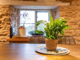 A dining room with a plant on a table at The Old Barn in Manchester