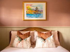 A bedroom with a bed and decorative pillows at 