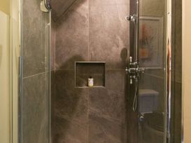 A shower with glass door and wall niche in a bathroom