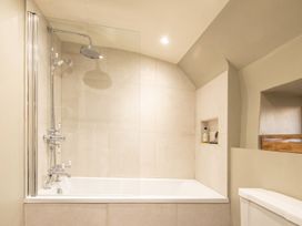 A bathroom with a bathtub and shower at The Old Barn in Manchester