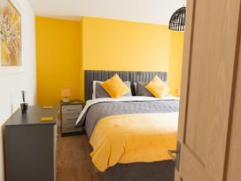 A bedroom with a bed and bedside table at The Old Barn in Manchester