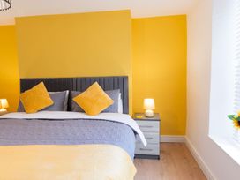 A bedroom with a bed and bedside table at The Old Barn in Manchester