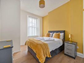 A bedroom with a bed and bedside table at The Old Barn in Manchester