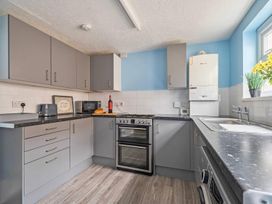 A kitchen with cabinets, oven, sink, and appliances at The Old Barn in Manchester