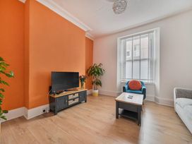 A living room with a television and sofa at '' in ''