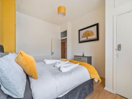 A bedroom with a bed and a chest of drawers at The Old Barn in Manchester