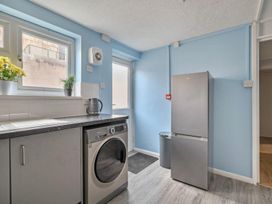 A laundry room with a washing machine and refrigerator at the property in 