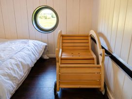 A bedroom with a bed and a wooden cart at The Old Barn in Manchester