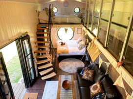A living room with a sofa and staircase at a property