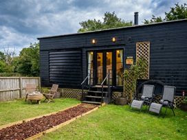 A house with garden furniture and a pathway in front of it at the cabin in a rural area
