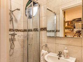A bathroom with a shower and sink at The Old Barn in Manchester