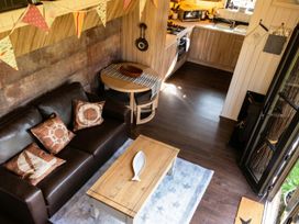 A living room with a sofa and a dining table at The Old Barn in Manchester