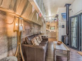 A living room with a sofa and a lamp at The Old Barn in Manchester