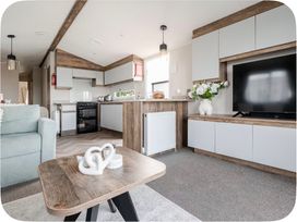 A living room with a sofa and coffee table at Brookwood Willerby, 36 bay view, Filey