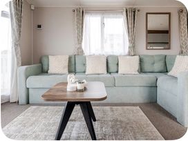 A living room with a sofa and coffee table at Brookwood Willerby, 36 bay view, Filey