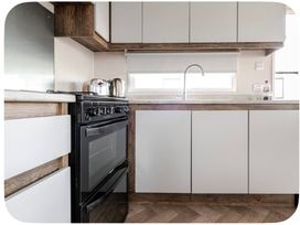 A kitchen with an oven, sink, and kettle at Brookwood Willerby, 36 bay view, Filey