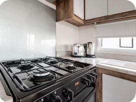 A kitchen with gas stove and appliances at Brookwood Willerby, 36 bay view, Filey