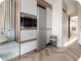 A kitchen with refrigerator and microwave at Brookwood Willerby, 36 bay view, Filey