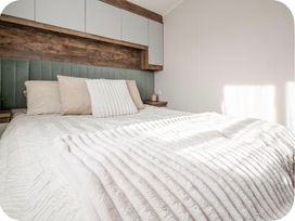A bedroom with a bed and pillows at Brookwood Willerby, 36 bay view, Filey