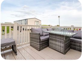 Outdoor seating area with a table and cushions at Brookwood Willerby, 36 bay view, Filey