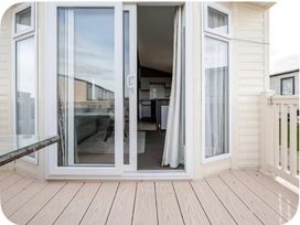 A balcony with a sliding door leading to an interior at Brookwood Willerby, 36 bay view Filey