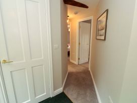 A hallway with doors and carpet at Swallow's Nest in Keswick