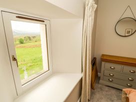 A bedroom with a window and a drawer unit at Swallow's Nest in Keswick