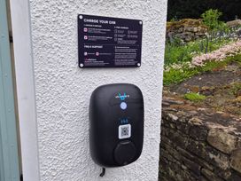 An electric car charging station with instructions at Swallow's Nest Keswick