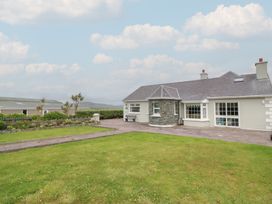 A house with a garden and pathway at Wild Atlantic Way Country Cottage in Portmagee, County Kerry