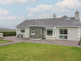 A house with stone feature and garden at Wild Atlantic Way Country Cottage in Portmagee, County Kerry