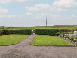An outdoor area with hedges and a flower bed at Wild Atlantic Way Country Cottage, Portmagee, County Kerry