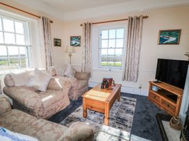 A living room with a coffee table and sofa at Old Higher Lighthouse Stopes Cottage Portland Bill