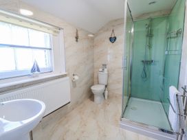 A bathroom with a sink, toilet, and shower at Old Higher Lighthouse Stopes Cottage Portland Bill