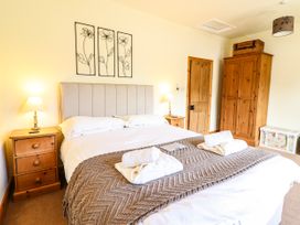 A bedroom with a bed and bedside tables with lamps at 3 Railway Cottages in Betws-y-Coed