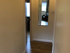 A hallway with a mirror and a door at Primrose Lodge in Saltburn-by-the-Sea