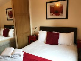 A bedroom with a bed and a bedside table at Primrose Lodge in Saltburn-by-the-Sea