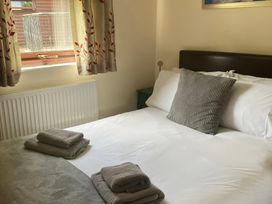 A bedroom with a bed and towels at Primrose Lodge Saltburn-by-the-Sea