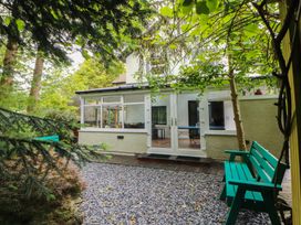 A garden with a house and seating at Eden House in Bardsea
