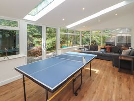 A snug with a ping pong table and a sofa at Eden House in Bardsea