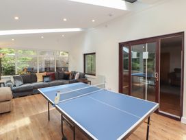 A playroom with a table tennis table and a sofa at Eden House in Bardsea