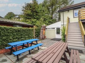 An outdoor area with picnic tables and stairs at Eden House in Bardsea